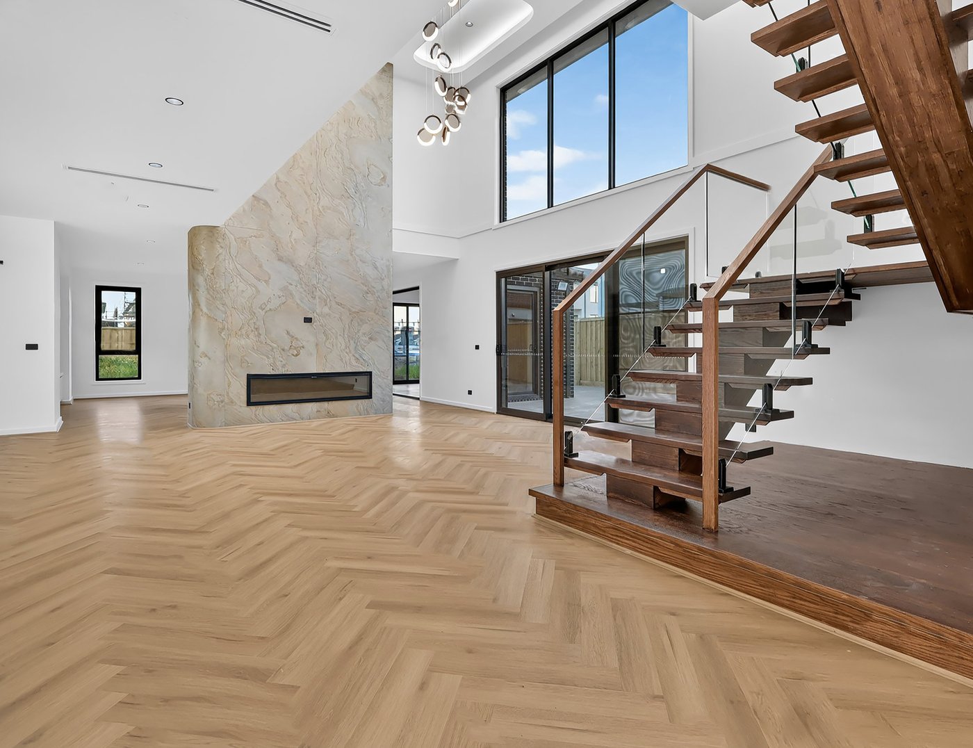 Final colour-graded edit of the same living room with feature fireplace and staircase