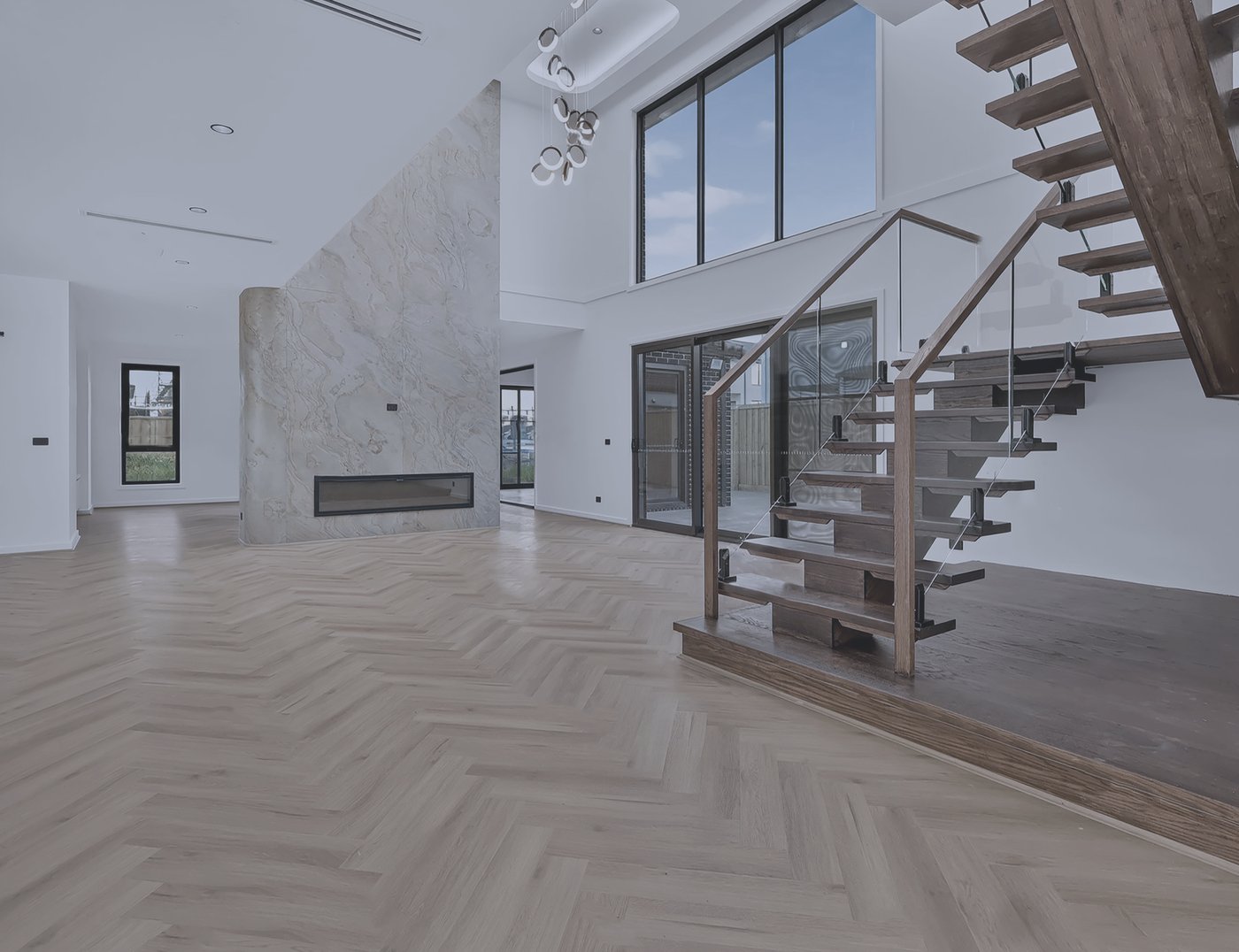 Unedited raw capture of a Melbourne home living room with feature fireplace and staircase