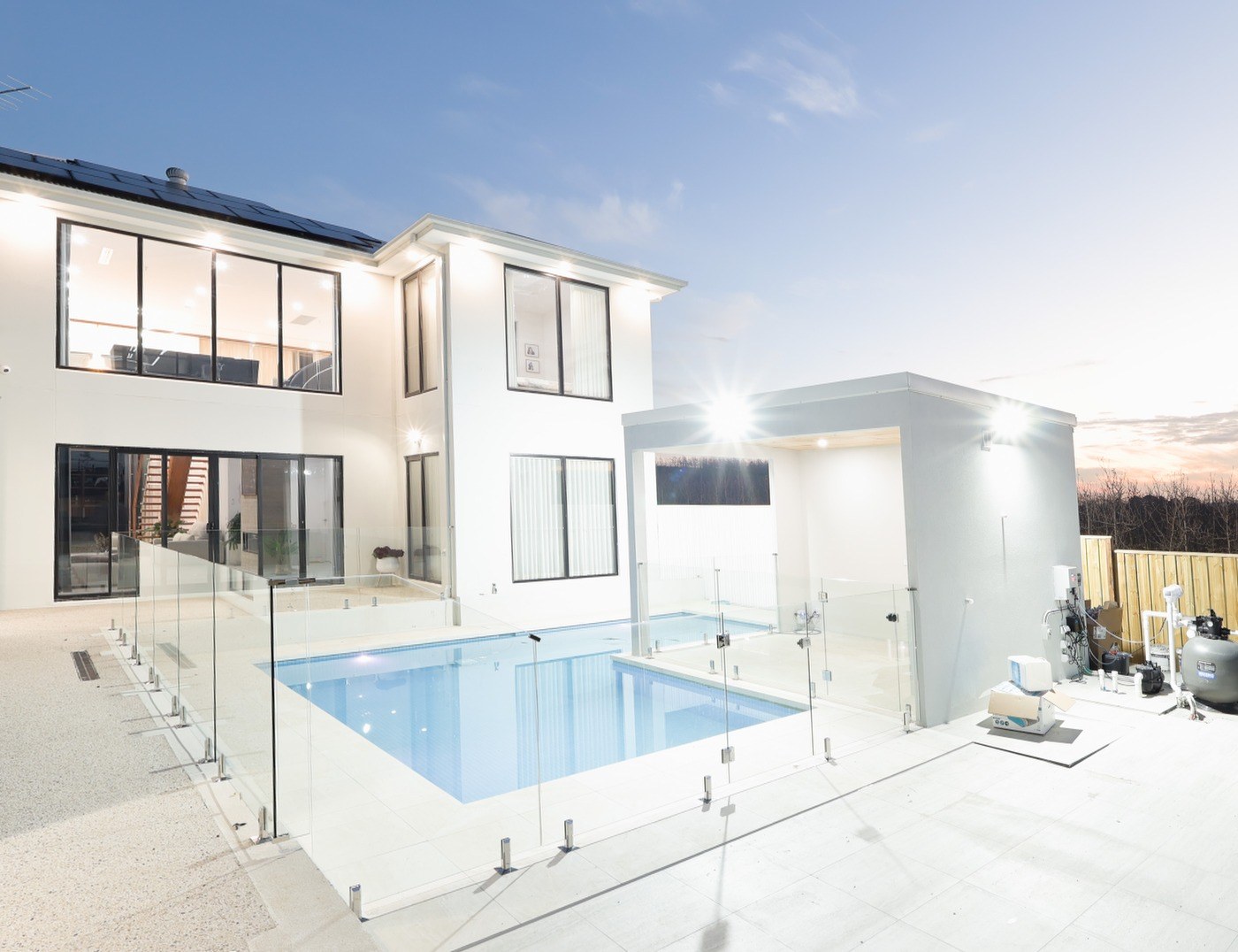 Unedited raw capture of a Melbourne home's rear yard and pool at twilight